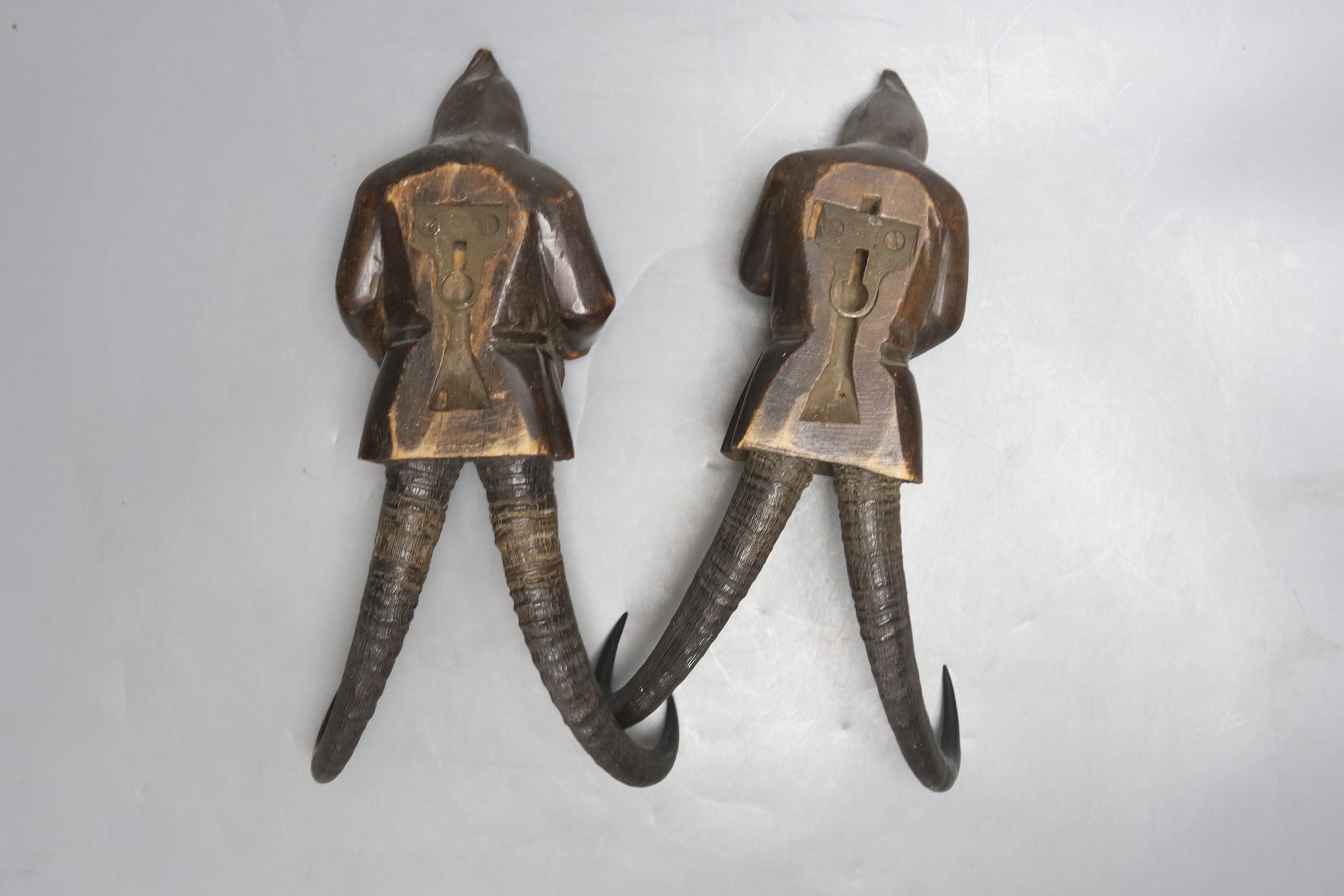Two Black Forest chamois antler whip hooks, each with carved wood figural 'gnome' surmount